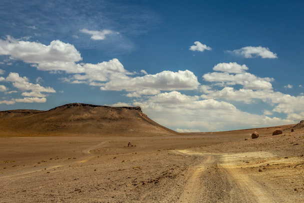 Dirt Road in Peaceful Moon Valley dramatic landscape at Sunset, Atacama Desert, Chile - Photo, Image