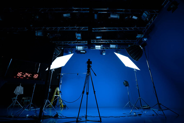 Professional video studio behind-the-scenes video footage behind-the-scenes silhouette production photography with a focus on camera and studio equipment. - Photo, Image