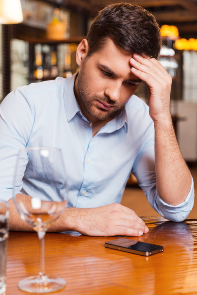 Frustrated young man at restaurant - Fotoğraf, Görsel