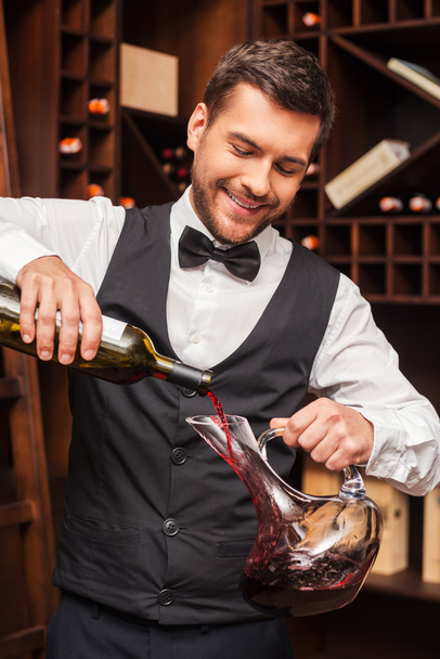 Sommelier pouring red wine - 写真・画像