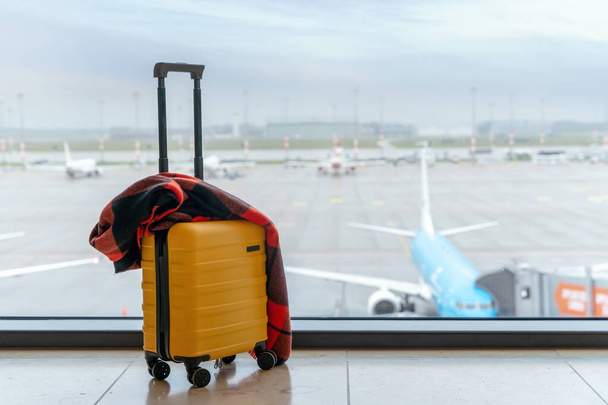 Yellow Suitcases in an airport against a plane. Travel concept. - Foto, Imagen