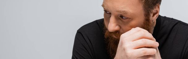 portrait of thoughtful bearded man with hands near face looking away isolated on grey, banner - Foto, immagini