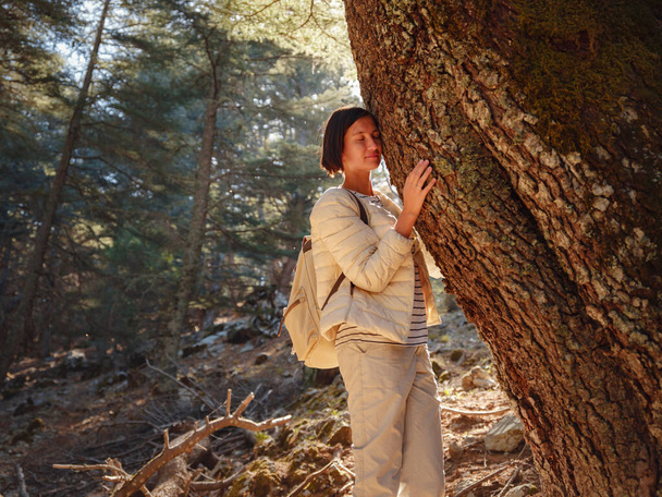 asian woman enjoys being in nature, beautiful forest in mountains. embracing fresh air and engaging in outdoor activities. Friluftsliv concept means spending as much time outdoors as possible - Photo, image