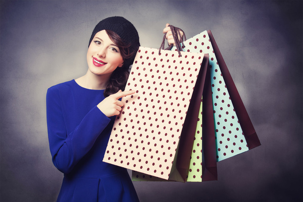women in blue dress with shopping bags - Photo, Image