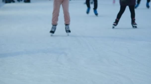 People are skating on the ice rink during the winter holidays. - Felvétel, videó