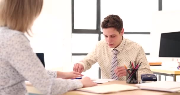 Manager gives contract to specialist for signing in office. Student employment and internship concept - Video