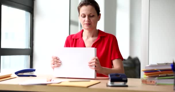 Woman secretary manager is holding stack of documents. Working with business documentation - Video
