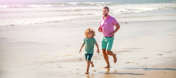 Banner of father and son run on summer sea beach. dad and child having fun outdoors. childhood and parenting. father and son. - Photo, Image