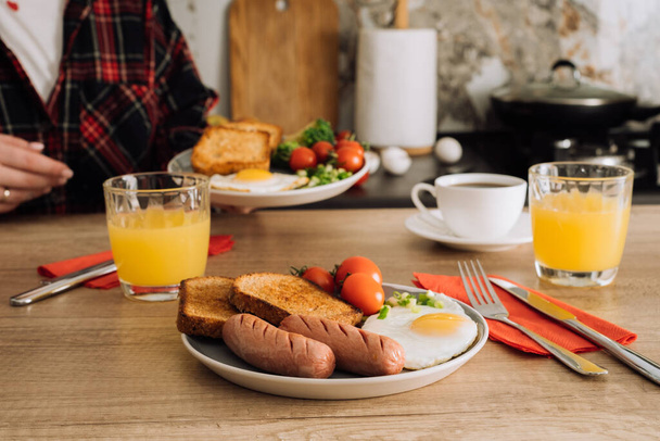 Μαγειρεμένα αγγλικά πρωινό με καφέ και χυμό πορτοκαλιού στην κουζίνα στο σπίτι - Φωτογραφία, εικόνα