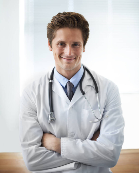 Confident hell find a way to help. Portrait of a positive looking young doctor standing with his arms crossed - Fotoğraf, Görsel