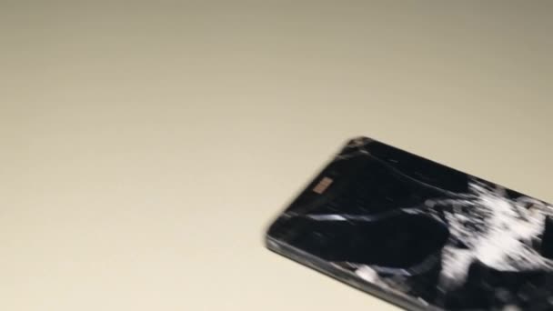 Super slow motion of a broken smartphone falling down. Cracked glass in the gadget. Smashed phone. - Metraje, vídeo