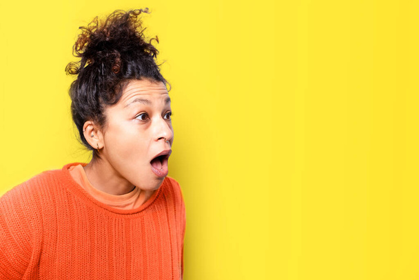 Amazed and astonished face expression on yellow background - Fotó, kép