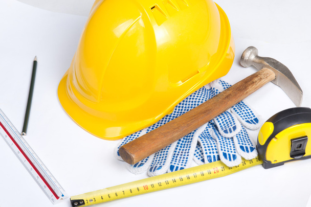 close up of builder's helmet and work tools over white - Photo, Image