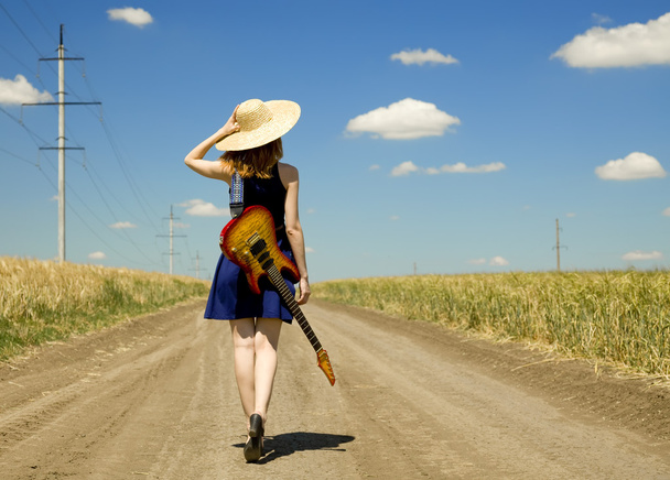 Rock girl with guitar at countryside. - Foto, imagen