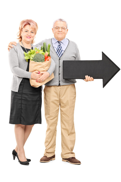 Mature couple holding groceries - Fotó, kép