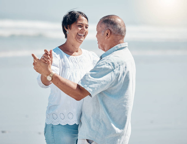 Senior couple, beach and dancing for love, care and romance on summer holiday, vacation and date. Happy man, woman and dance at sea for anniversary, smile and support in nature, sunshine and marriage. - Fotografie, Obrázek