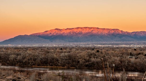 Albuquerque, New Mexico at sunset with Rio Grande in the front and the Sandia Mountains in the background. - Photo, image