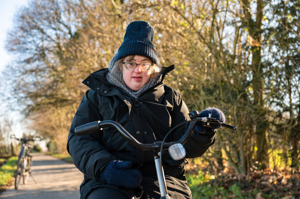 40 year old happy white woman with the Down Syndrome, wearing a hat and a winter jacket, Tienen, Flanders, Belgium - Foto, Imagem