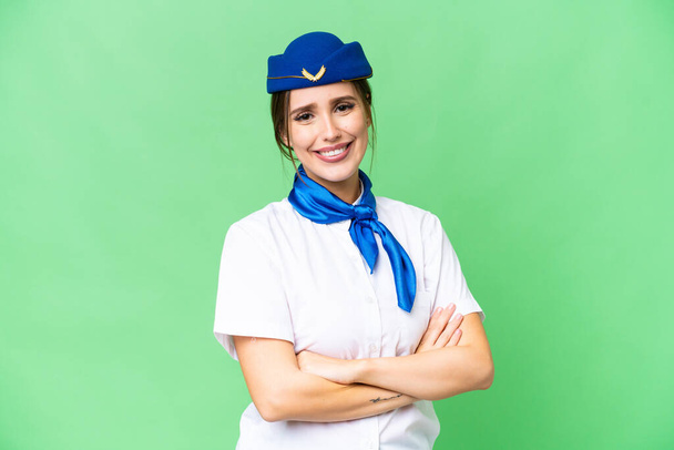 Airplane stewardess over isolated chroma key background with arms crossed and looking forward - Fotografie, Obrázek