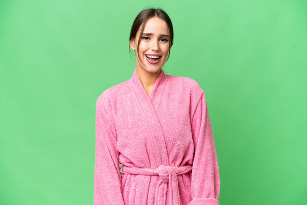 Young beautiful woman in a bathrobe over isolated chroma key background with surprise facial expression - Foto, afbeelding