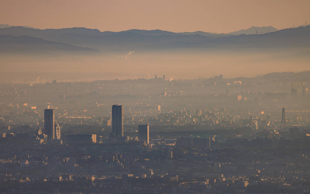 Early morning smog and haze over high rise apartments in sprawling city. High quality photo - Fotoğraf, Görsel