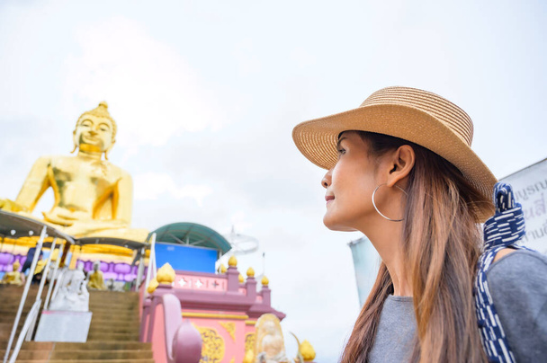 A Woman Traveler with Golden Buddha Background at Golden Triangle, Chiang Rai Province. - Foto, imagen