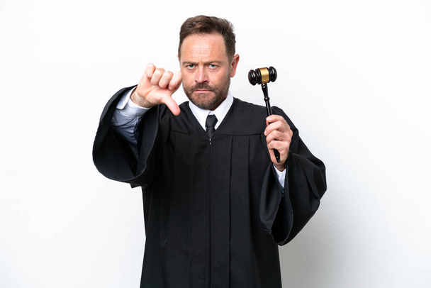 Middle age judge man isolated on white background showing thumb down with negative expression - Foto, imagen