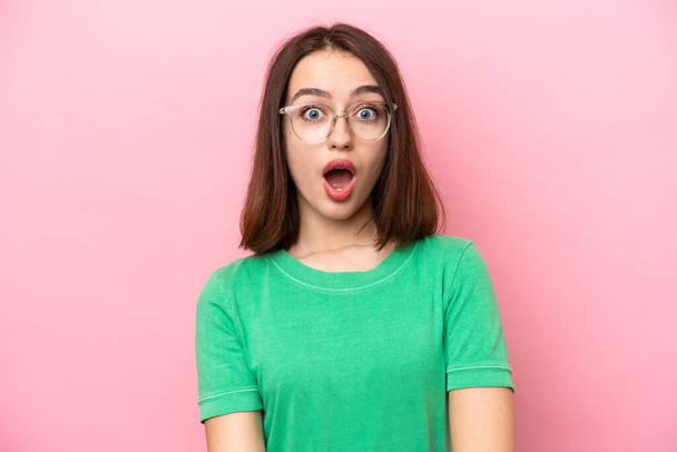 Young Ukrainian woman isolated on pink background With glasses and surprised expression - Photo, Image