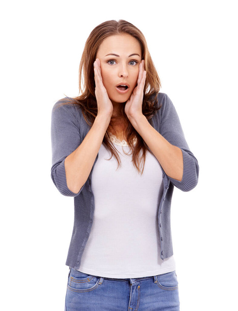 Oh no, thats awful. Casually dressed woman looking surprised while isolated on white - 写真・画像