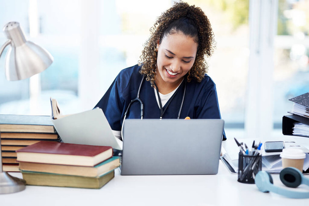 Woman, laptop or medical student books for research, education studying or college learning in university hospital. Smile, happy or healthcare nurse with technology in scholarship medicine internship. - Photo, Image