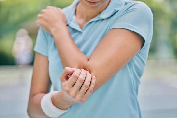 Sports, woman and injury with elbow, pain and muscle strain while training, workout and outdoor fitness. Female, lady and athlete with emergency for arm, inflammation and broken bone while on court. - Foto, immagini