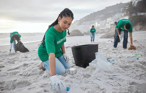 チームワーク、持続可能性、環境、環境に優しいビーチで黒人女性との清掃とリサイクル。地域奉仕のためのボランティアとプラスチックで気候変動、地球の日と自然. - 写真・画像