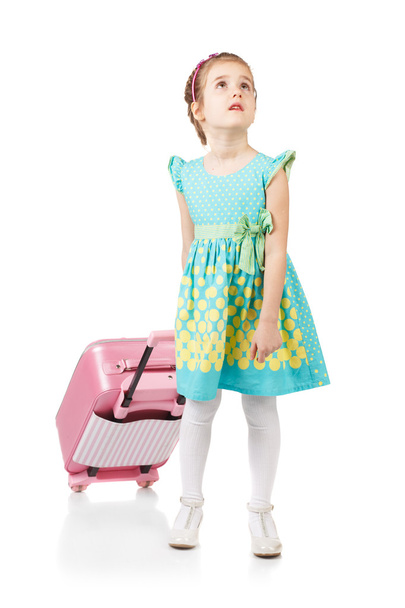 Pretty girl sitting on a suitcase - Zdjęcie, obraz