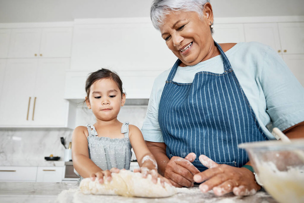 Learning, cooking dough and grandmother with girl in kitchen baking dessert or pastry. Education, family care and happy grandma teaching kid how to bake, bonding and enjoying quality time together - Photo, image