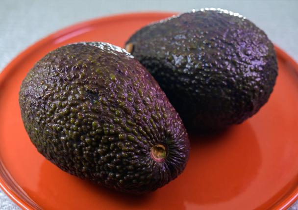 Two fresh ripe raw hass avocados, close up, healthy food concept close up - Foto, Bild