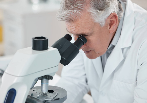 Qué curioso descubrimiento. un científico maduro usando un microscopio en un laboratorio - Foto, Imagen