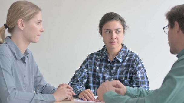 Az indiai és fehér nő hallgatja a férfi kollegát - Fotó, kép