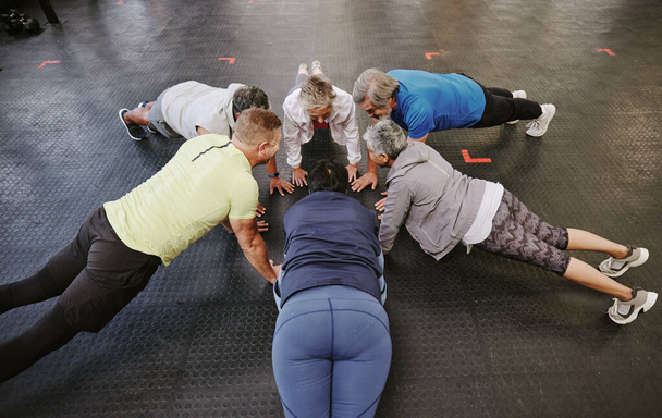 Push up, class and senior people in fitness group or circle for workout, training and community support. Exercise club, gym and lose weight of elderly friends with teamwork, sports goals and health. - Fotó, kép