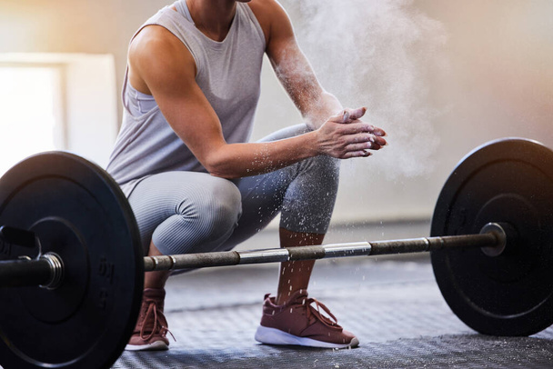 Hands, bodybuilding and powder with a woman weight lifter getting ready to exercise or workout at gym. Fitness, grip and training with a female bodybuilder weightlifting for strong muscles or health. - Fotoğraf, Görsel