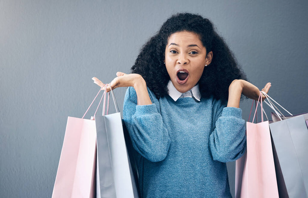 Wow, discount and portrait of woman with shopping bags, retail therapy and surprise at sale on wall. Deal, excited and happy girl holding products from a shop, market or mall on a background. - Fotografie, Obrázek