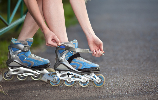 Young woman put on roller-skate close up - Fotó, kép