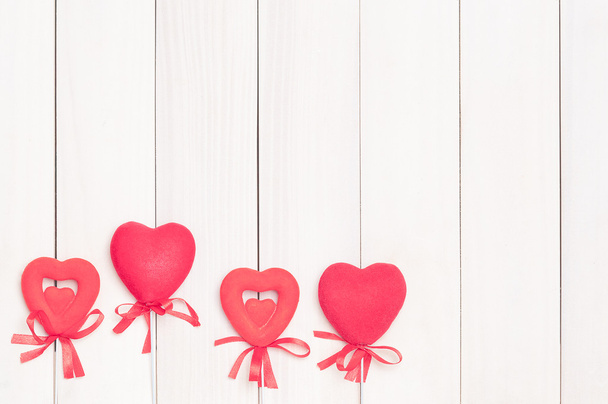 Four red hearts on sticks. - Foto, Imagen