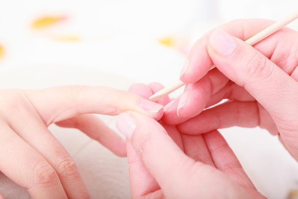 Beautician cleaning cuticles - Фото, изображение