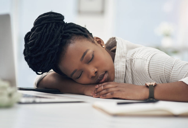 Ill just close my eyes for a little bit. a young businesswoman taking a nap on her desk at work - Fotó, kép