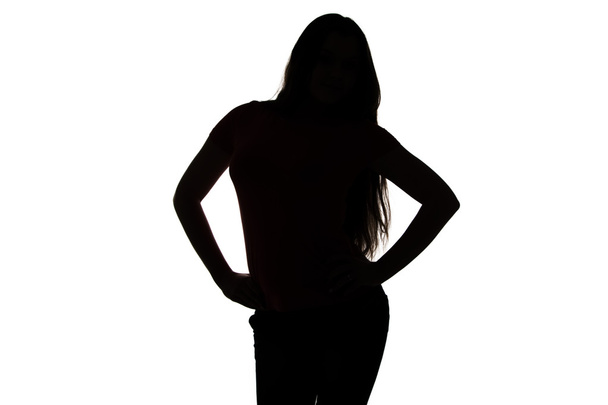 Silhouette of teenager with hands on hip - Φωτογραφία, εικόνα