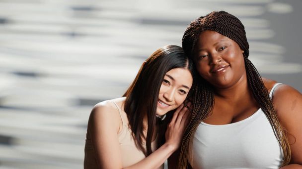 Diverse women showing body positivity and acceptance, group of people with different body types and skintones. Plus size and skinny models being natural and cheerful on camera. - Foto, Imagen
