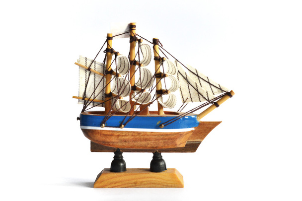 Wooden model ship with sails on a white background - 写真・画像