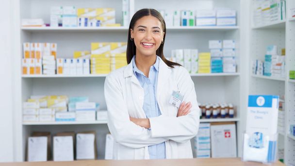 Portrait of a cheerful and friendly pharmacist using a digital tablet to check inventory or online orders in a chemist. Young latino woman using pharma app to do research on medication in a pharmacy. - Zdjęcie, obraz