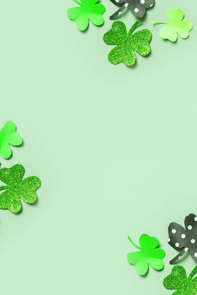 St. Patrick's Day balnk greeting card. Paper clover leaves on colored background with copy space. - 写真・画像