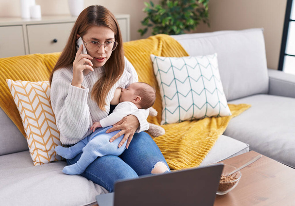 Mother and son breastfeeding baby teleworking at home - Фото, зображення
